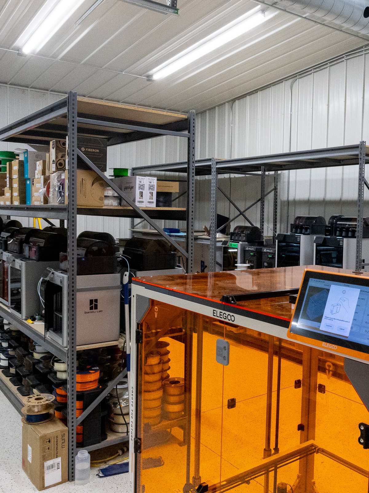 Filament printers and racked spool stock on the FDM floor