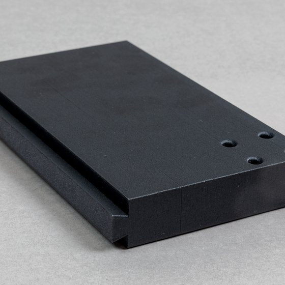 Black printed mounting plate with bolt holes